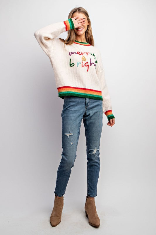Model wearing Merry & Bright holiday sweater with colorful embroidery and striped rib trim — Social Dizfunksion Clothing Co.