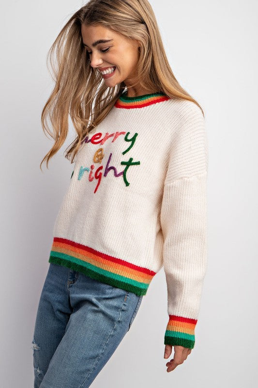 Model wearing Merry & Bright holiday sweater with colorful embroidery and striped rib trim — Social Dizfunksion Clothing Co.