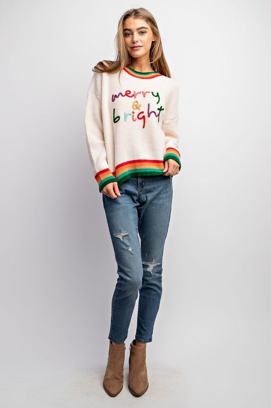 Model wearing Merry & Bright holiday sweater with colorful embroidery and striped rib trim — Social Dizfunksion Clothing Co.