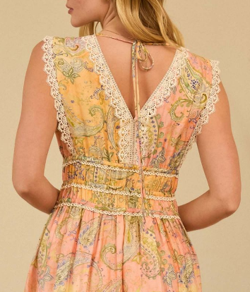 Back view of person wearing a pastel paisley print maxi dress with lace-trim V-back, smocked waist, and tie-back neck detail.