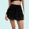 A pair of black lace tiered shorts with ruffle detail, shown from the waist to mid-thigh on a model.
