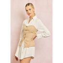 Woman wearing a white shirt and beige vest over a white skirt on a pink background